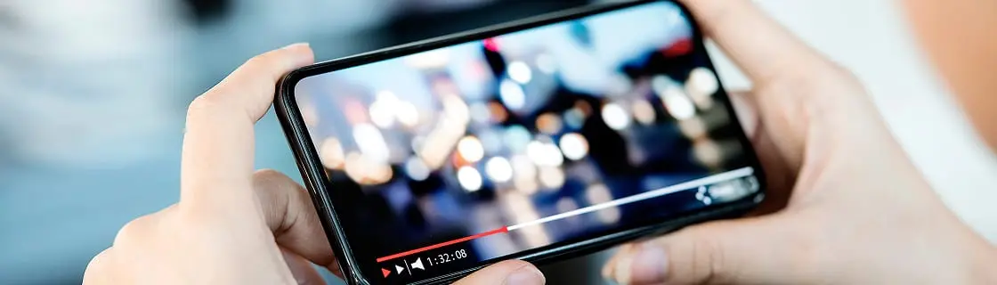 スマホで動画を再生する手のクローズアップ